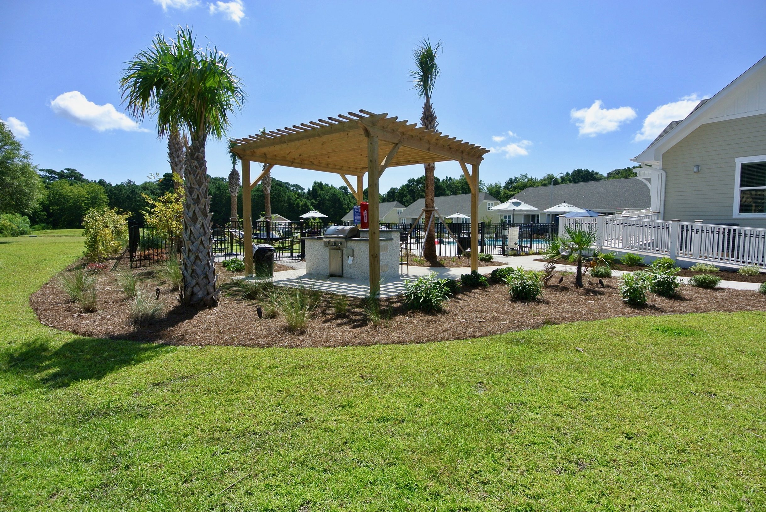 Luxury Townhomes in Wilmington, NC - Myrtle Landing Outdoor BBQ Grill Pavilion Surrounded by Lush Landscaping